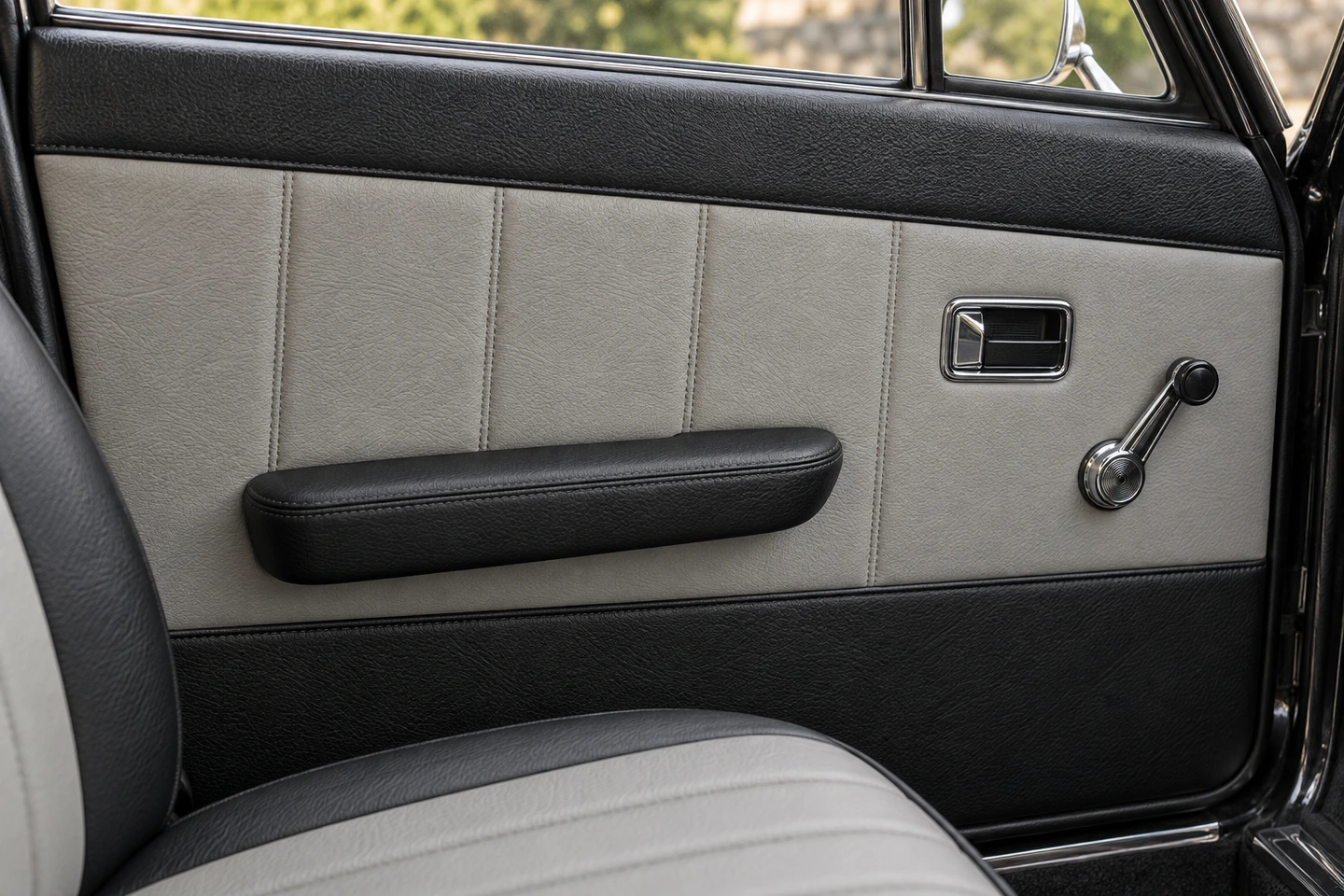 Upholstery concept showing black and light grey panels on a classic car door