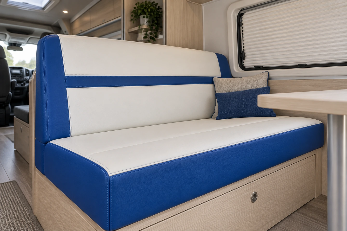 Illustrative royal blue and white bench upholstery inside an enclosed campervan